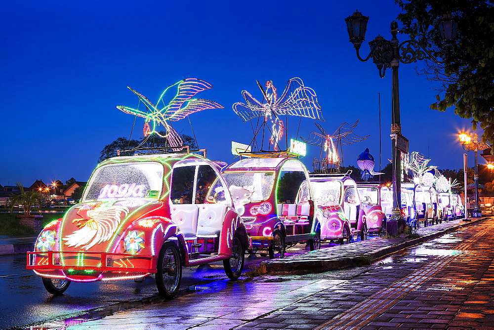 Brightly coloured illuminated pedal cars in Yogyakarta city, Java, Indonesia, Southeast Asia, Asia