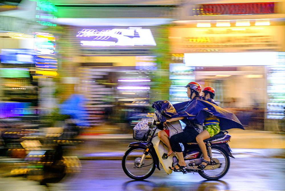 Motorbike riders in the rain in Ho Chi Minh City, Vietnam, Indochina, Southeast Asia, Asia