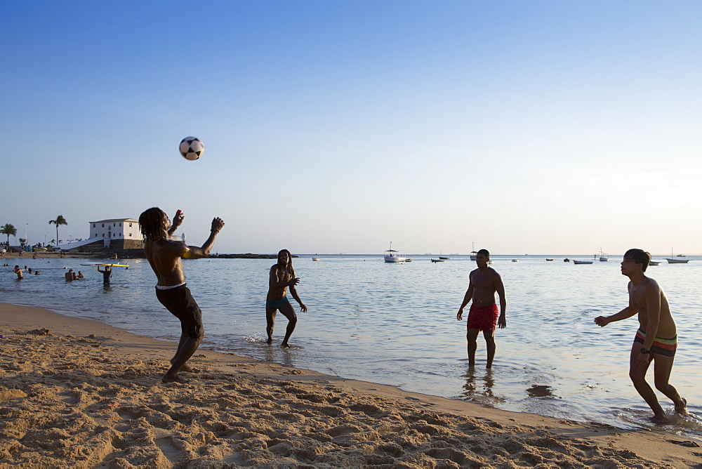 Locals playing football on Barra beach, Salvador, Bahia, Brazil, South America