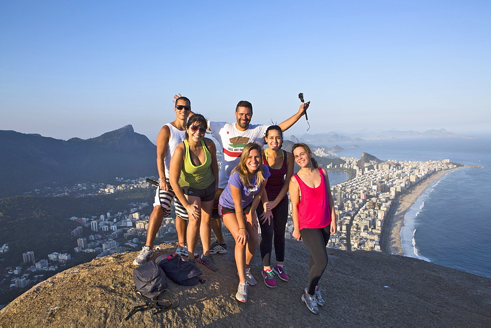 Local tourists on the summit of Dois Irmaos peak (Two Brothers Peak) with Ipanema, Corcovado and Rio city below, Rio de Janeiro, Brazil, South America