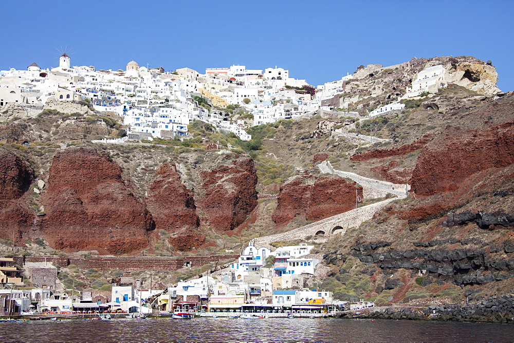 Typical Greek village perched on volcanic rock with white and blue houses and windmills, Santorini, Cyclades, Greek Islands, Greece, Europe