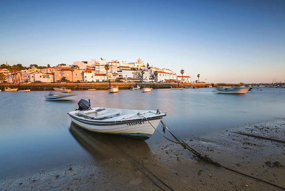 The colors of sunset on the fishing village of Ferragudo, Portimao, Algarve, Lagoa Faro District, Portugal, Europe