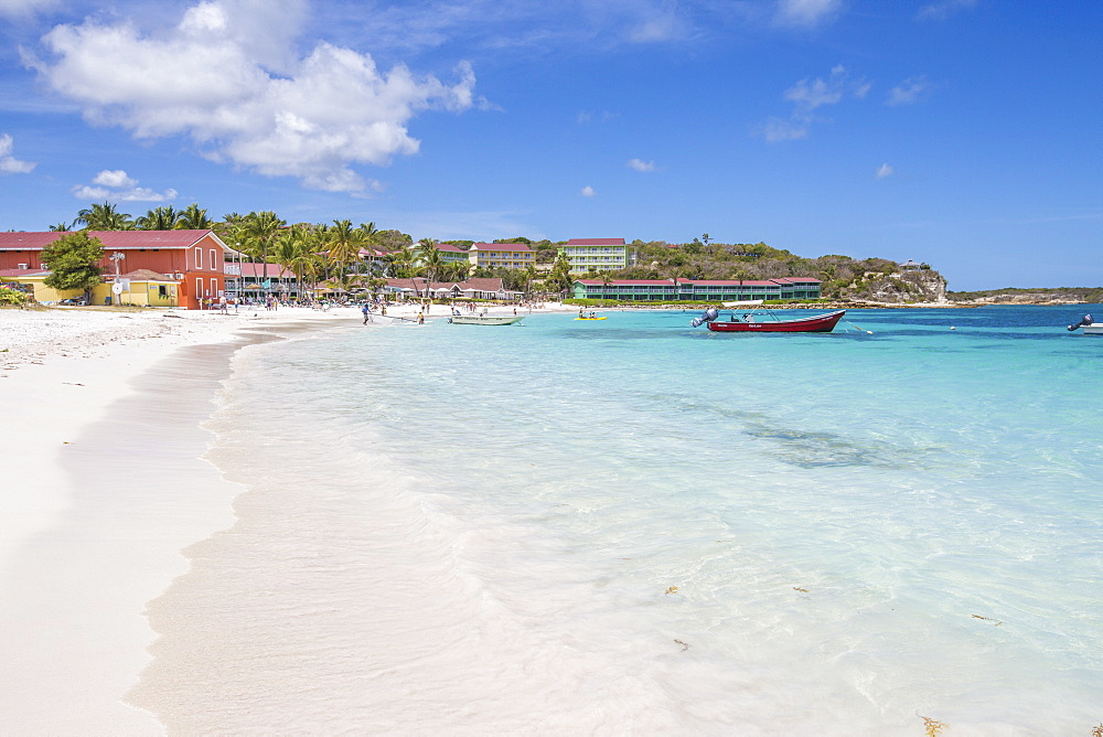 White sand and tourists frame the turquoise Caribbean sea at Long Bay Beach, Antigua and Barbuda, Leeward Islands, West Indies, Caribbean, Central America