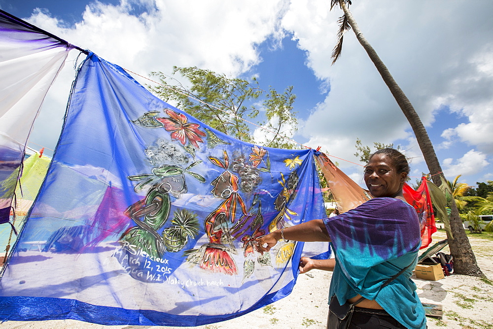 Woman smiling showing the typical colors of the island, The Nest, Antigua, Antigua and Barbuda, Leeward Islands, West Indies, Caribbean, Central America