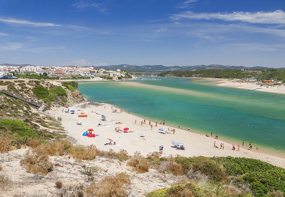 View of the sandy beach of Vila Nova de Milfontes surrounded by the turquoise ocean, Odemira, Alentejo region, Portugal, Europe