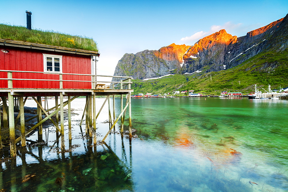 Typical house of fishermen called Rorbu lit up by midnight sun, Reine, Nordland county, Lofoten Islands, Arctic, Northern Norway, Scandinavia, Europe