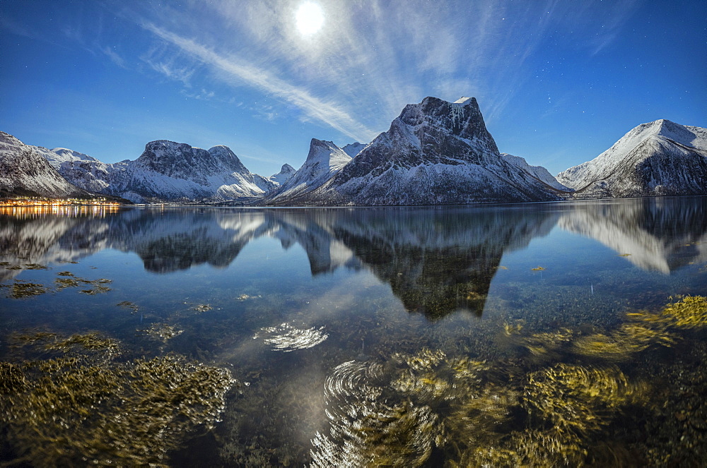 Panorama of snowy peaks reflected in sea in a cold starry night, Bergsbotn, Senja, Troms County, Norway, Scandinavia, Europe