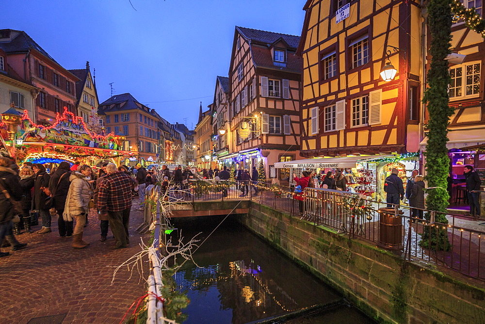 Tourists shopping at the Christmas Markets in the old medieval town of Colmar, Haut-Rhin department, Alsace, France, Europe