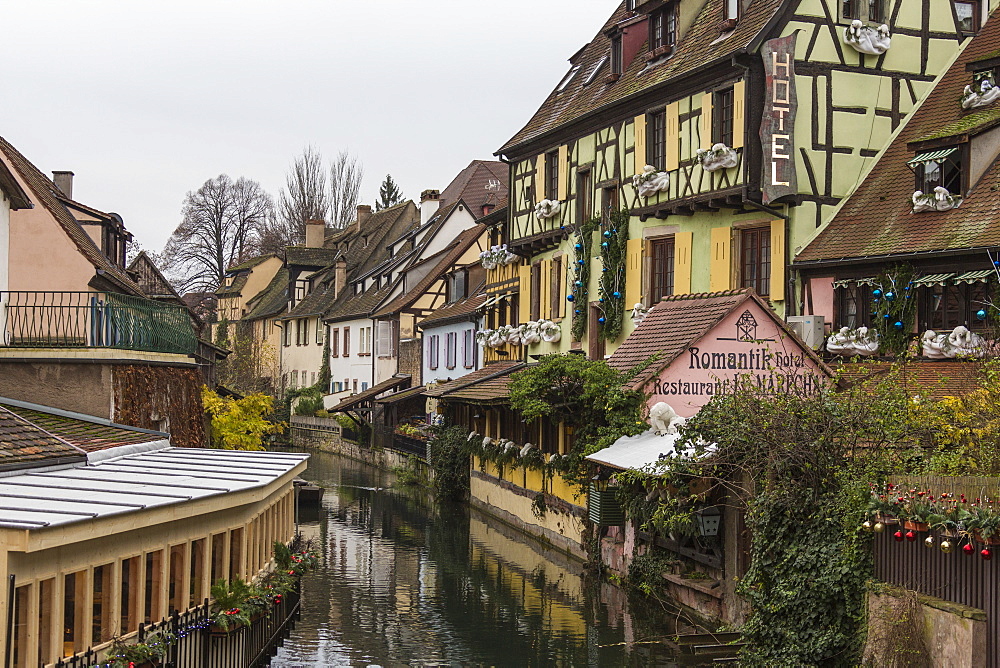 Colored houses reflected in river Lauch at Christmas time, Petite Venise, Colmar, Haut-Rhin department, Alsace, France, Europe