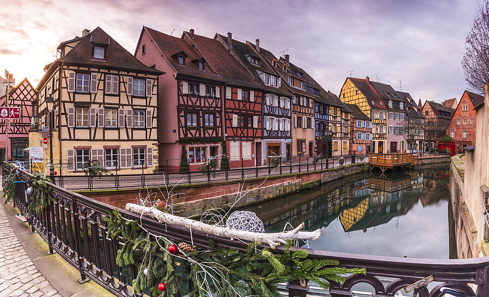 Colored houses reflected in River Lauch at sunset, Petite Venise, Colmar, Haut-Rhin department, Alsace, France, Europe