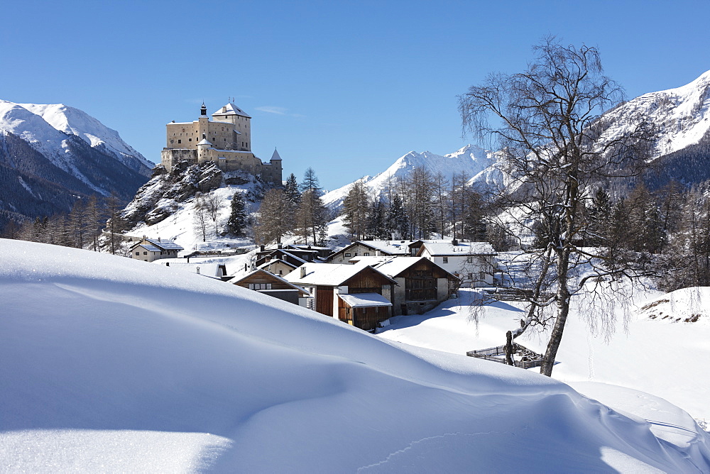 Old castle and alpine village of Tarasp surrounded by snowy peaks, Inn district, Canton of Graubunden, Engadine, Switzerland, Europe