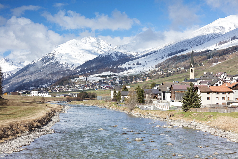 River Inn frames the alpine village of Zuoz surrounded by snowy peaks, Maloja, Canton of Graubunden, Engadine, Swiss Alps, Switzerland, Europe