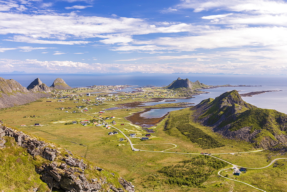 View of village of Sorland framed by green meadows and sea, Vaeroy Island, Nordland county, Lofoten archipelago, Norway, Scandinavia, Europe