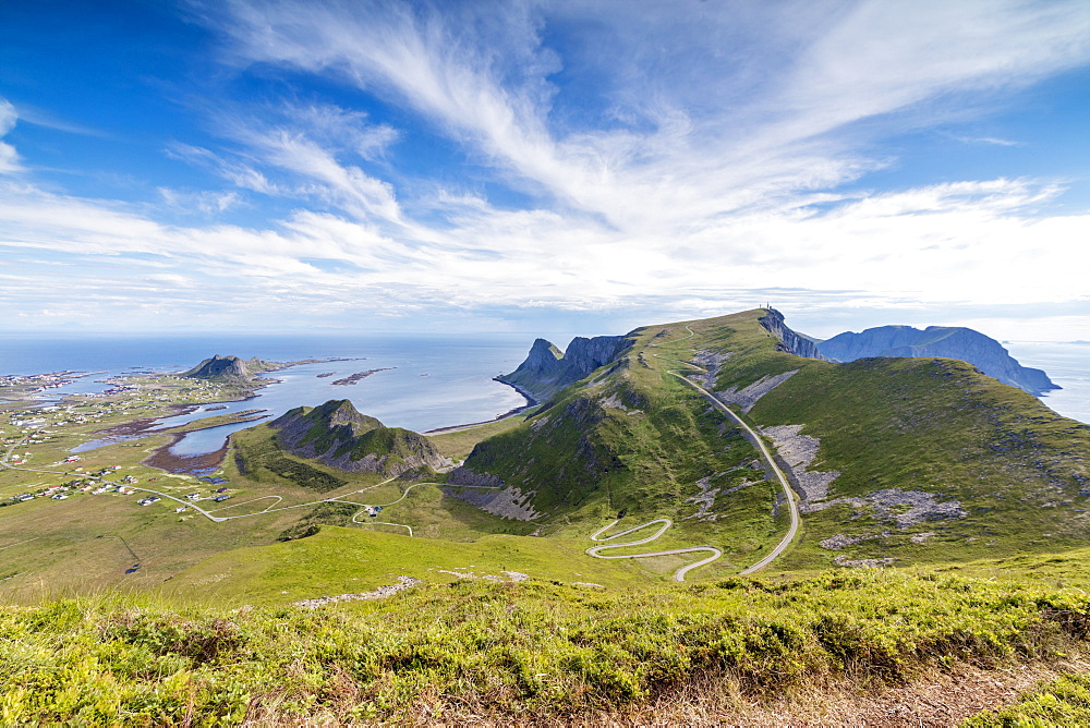 Steep road of curves in between green meadows and sea, Sorland, Vaeroy Island, county of Nordland, Lofoten Islands, Norway, Scandinavia, Europe