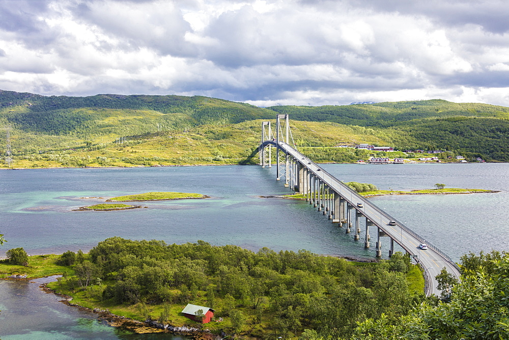 Green hills and turquoise sea frame the suspension road bridge in Tjeldsundbrua, Troms county, Nordland, Norway, Scandinavia, Europe