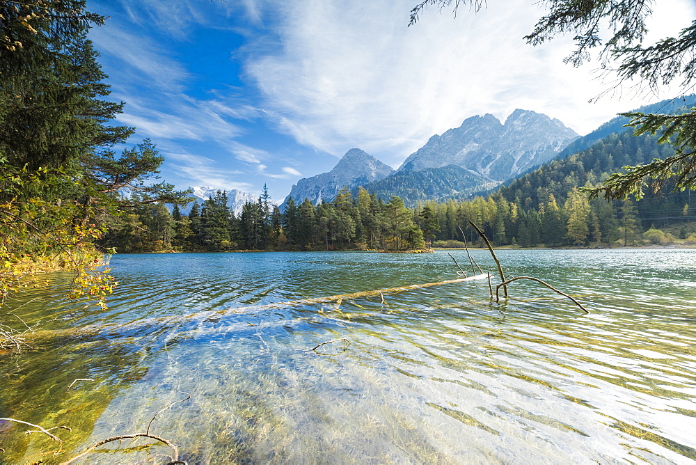 Lake Weissensee surrounded by woods with the Alps in the background, Biberwier, Carinthia, Tyrol, Austria, Europe