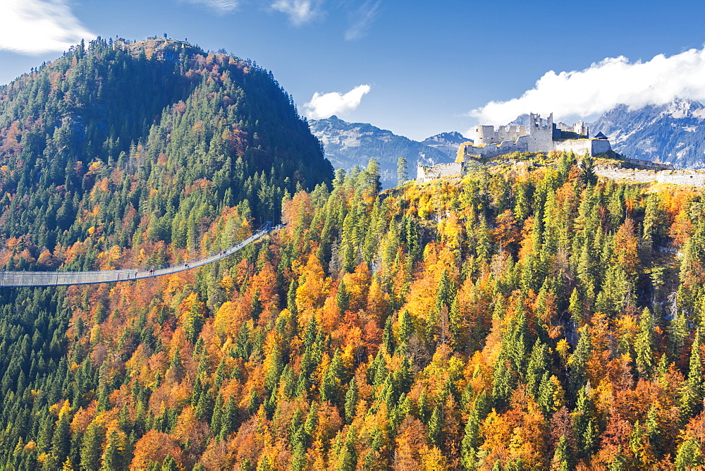 View of the old Ehrenberg Castle surrounded by colorful woods and suspension bridge, Highline 179, Reutte, Austria, Europe