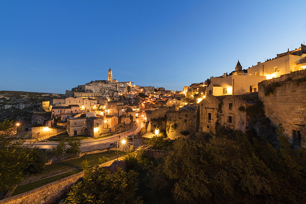 Dusk on the ancient town and historical center called Sassi, perched on rocks on top of hill, Matera, Basilicata, Italy, Europe