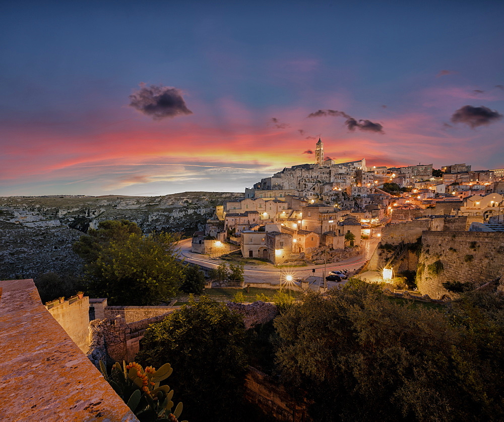 Sunset on the ancient town and historical center called Sassi, perched on rocks on top of hill, Matera, Basilicata, Italy, Europe