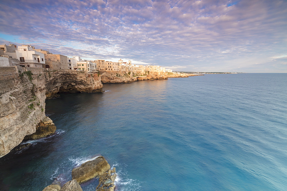 Sunrise on the turquoise sea framed by old town perched on the rocks, Polignano a Mare, Province of Bari, Apulia, Italy, Europe