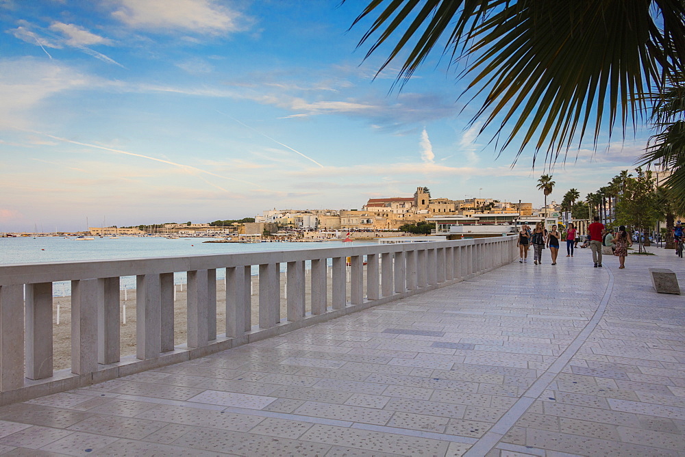 Tourists on the promenade with the medieval old town in the background, Otranto, Province of Lecce, Apulia, Italy, Europe