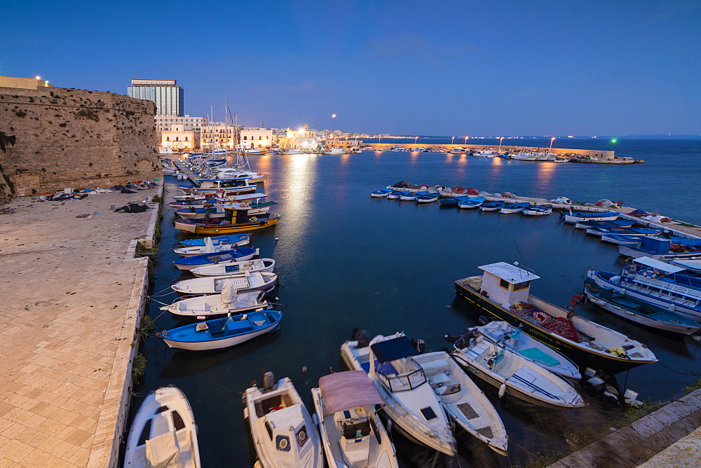 Dusk lights the harbor and the medieval old town of Gallipoli, Province of Lecce, Apulia, Italy, Europe