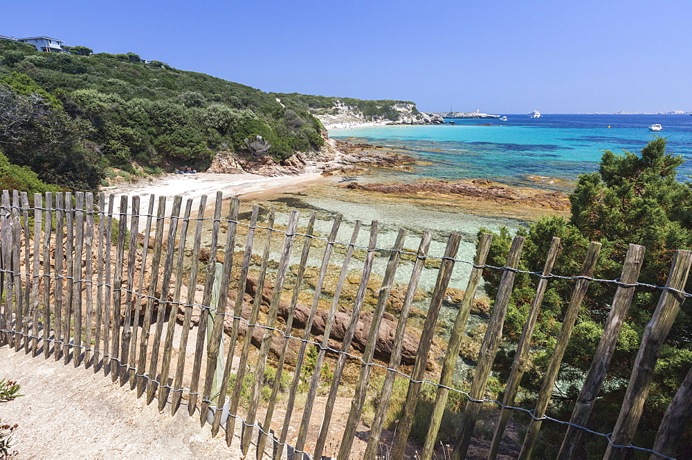 The wooden fence frames the limestone rocks and turquoise sea, Sperone, Bonifacio, South Corsica, France, Mediterranean, Europe