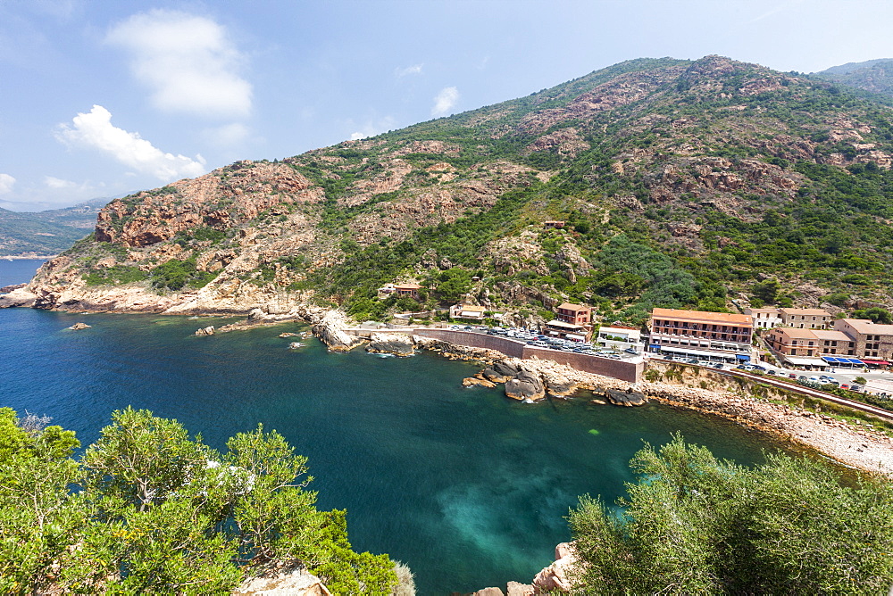 Top view of turquoise sea framed by green vegetation and the typical village of Porto, Southern Corsica, France, Mediterranean, Europe