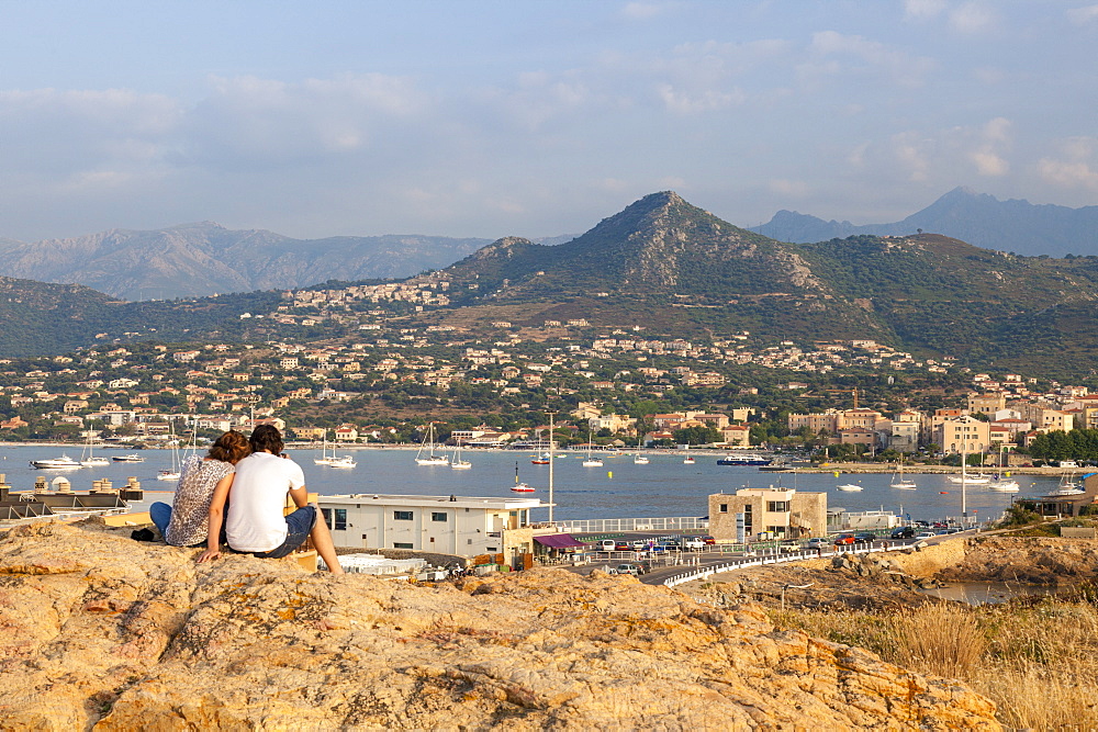 Tourists admire the sea and sail boats around the village of Ile Rousse, Balagne Region, Corsica, France, Mediterranean, Europe