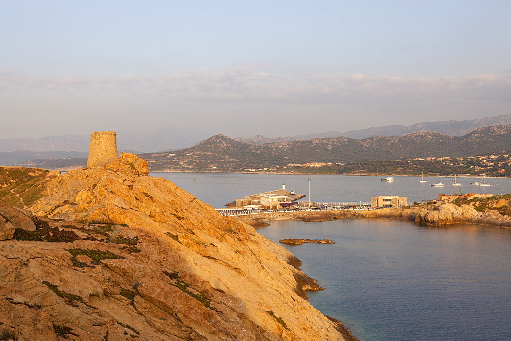 The ancient Genoese tower overlooking the blue sea surrounding the village of Ile Rousse, Balagne Region, Corsica, France, Mediterranean, Europe