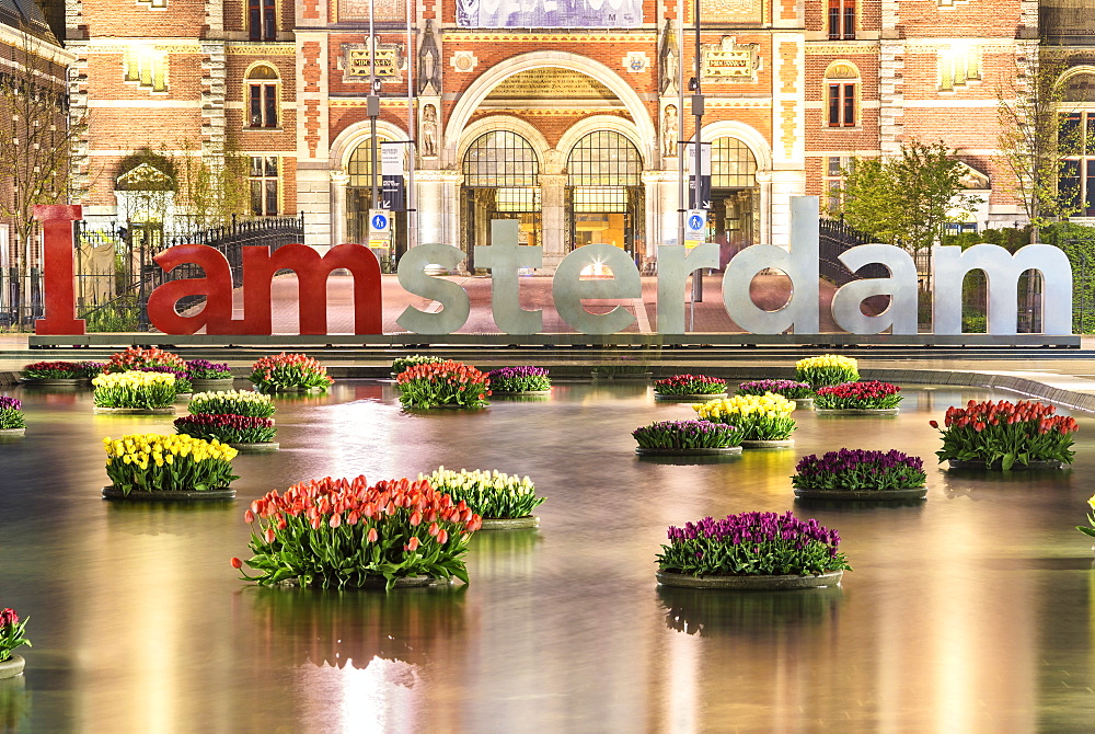 The National Rijksmuseum framed by vases of flowers floating in water, Amsterdam, Holland, The Netherlands, Europe