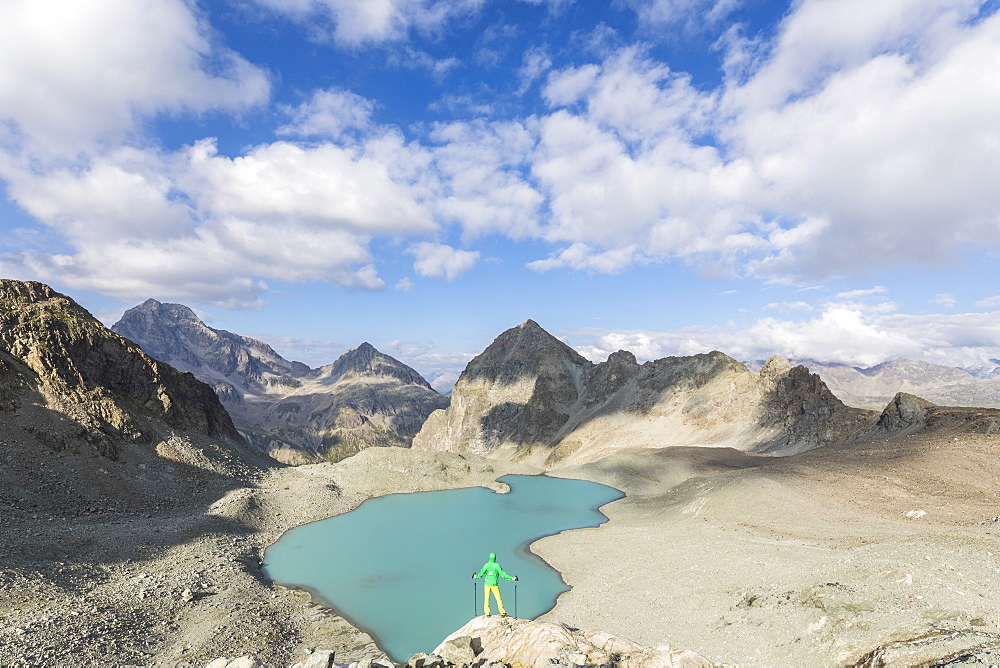 Hiker on the rocks overhanging Lej Lagrev, Silvaplana, Engadine, Canton of Graubunden, Switzerland, Europe