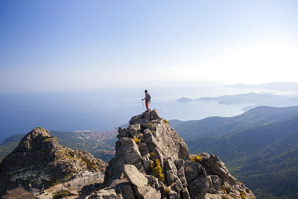 Hiker admires the sea from the top of Monte Capanne, Elba Island, Livorno Province, Tuscany, Italy, Europe