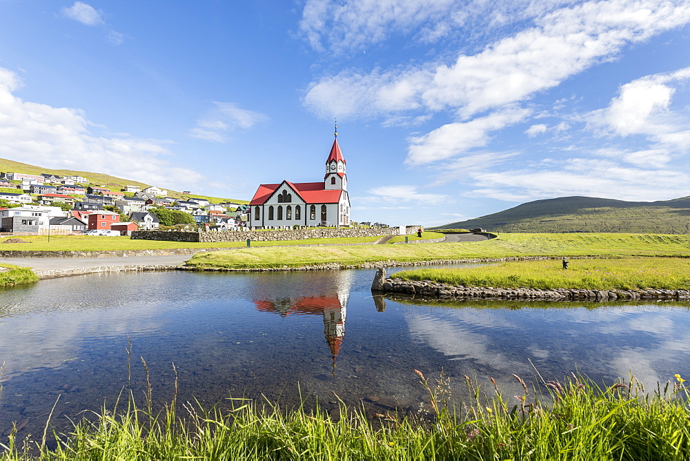 Church of Sandavagur reflected in water, Vagar Island, Faroe Islands, Denmark, Europe