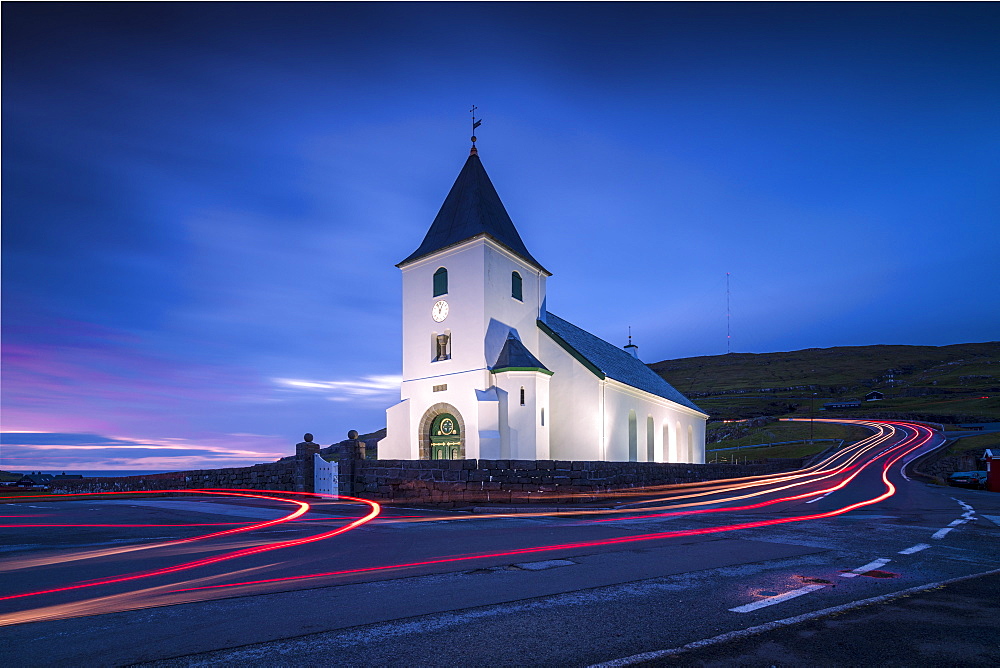 Lights of car trails at church of Eidi at dusk, Eysturoy Island, Faroe Islands, Denmark, Europe