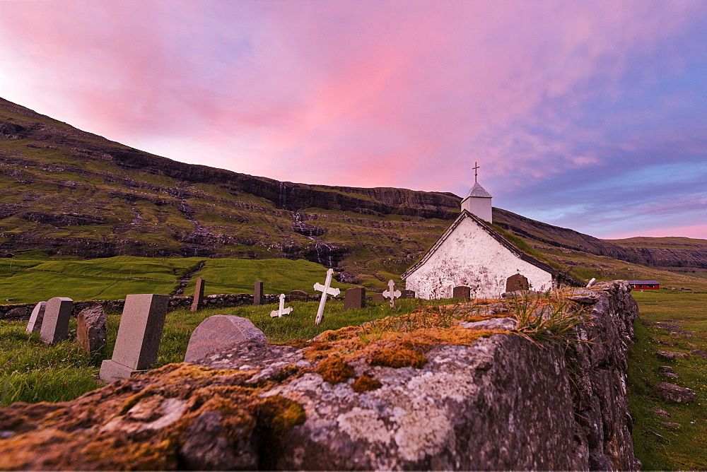 Pink sunset on church and cemetery, Saksun, Streymoy Island, Faroe Islands, Denmark, Europe