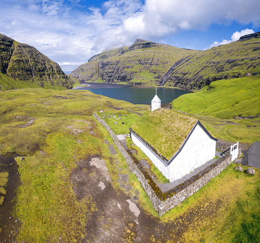 Elevated view of typical church in Saksun, Streymoy Island, Faroe Islands, Denmark, Europe (Drone)