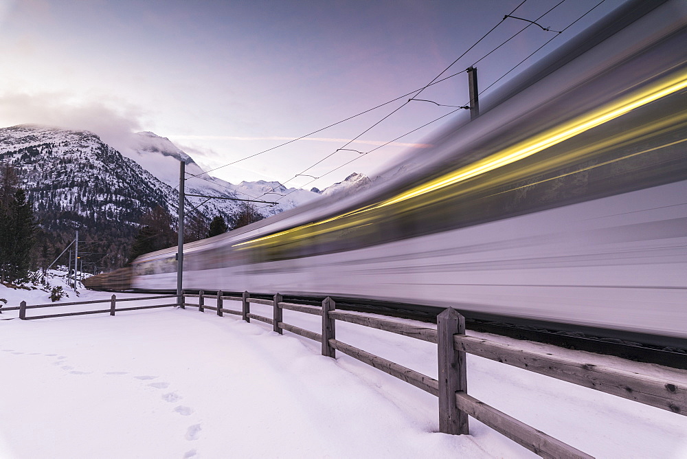 Bernina Express train in the snowy landscape, Morteratsch, Engadine, Canton of Graubunden, Switzerland, Europe