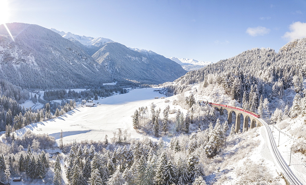 Panoramic of Bernina Express train on Landwasser Viadukt, UNESCO World Heritage Site, Filisur, Albula Valley, Canton of Graubunden, Switzerland, Europe (Drone)