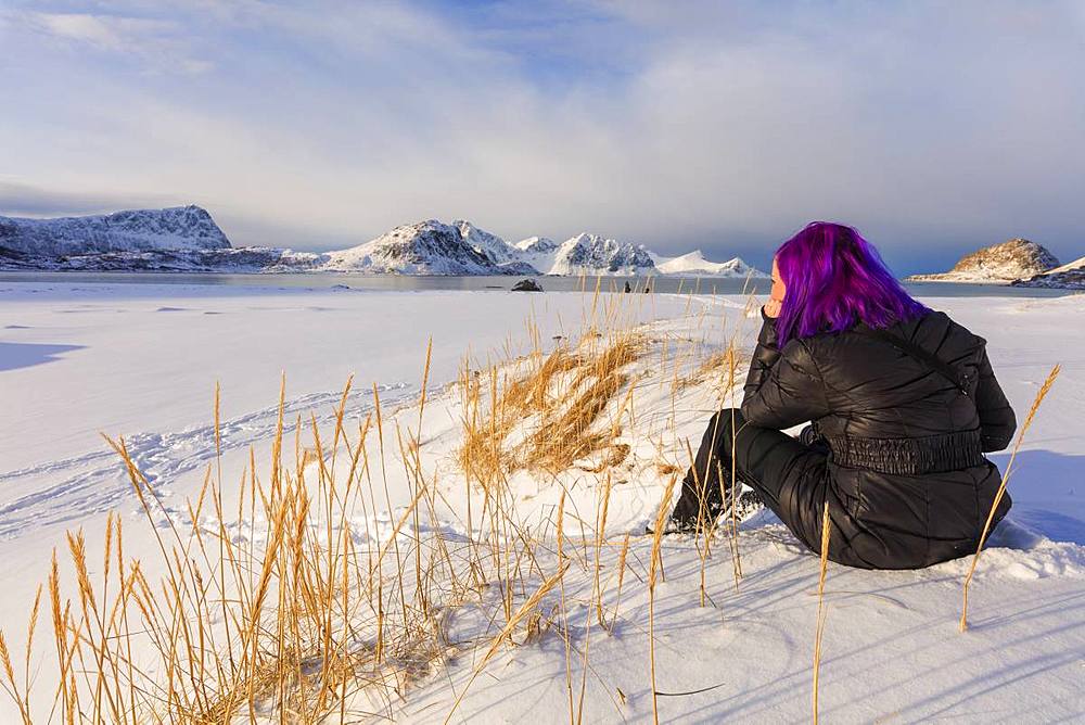 Woman on Haukland Beach covered with snow, Leknes, Vestvagoy, Lofoten Islands, Nordland, Norway, Europe