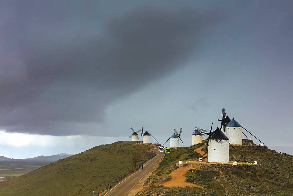 Storm clouds on windmills of Consuegra, Don Quixote route, Toledo province, Castilla-La Mancha (New Castile) region, Spain, Europe