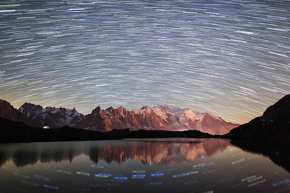 Star trail over Mont Blanc range seen from Lac des Cheserys, Parc Aiguilles Rouges, Haute Savoie, French Alps, France, Europe