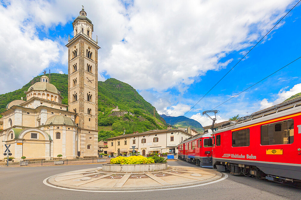 Bernina Express train next to historic Sanctuary of Madonna di Tirano, Sondrio province, Valtellina, Lombardy, Italy, Europe