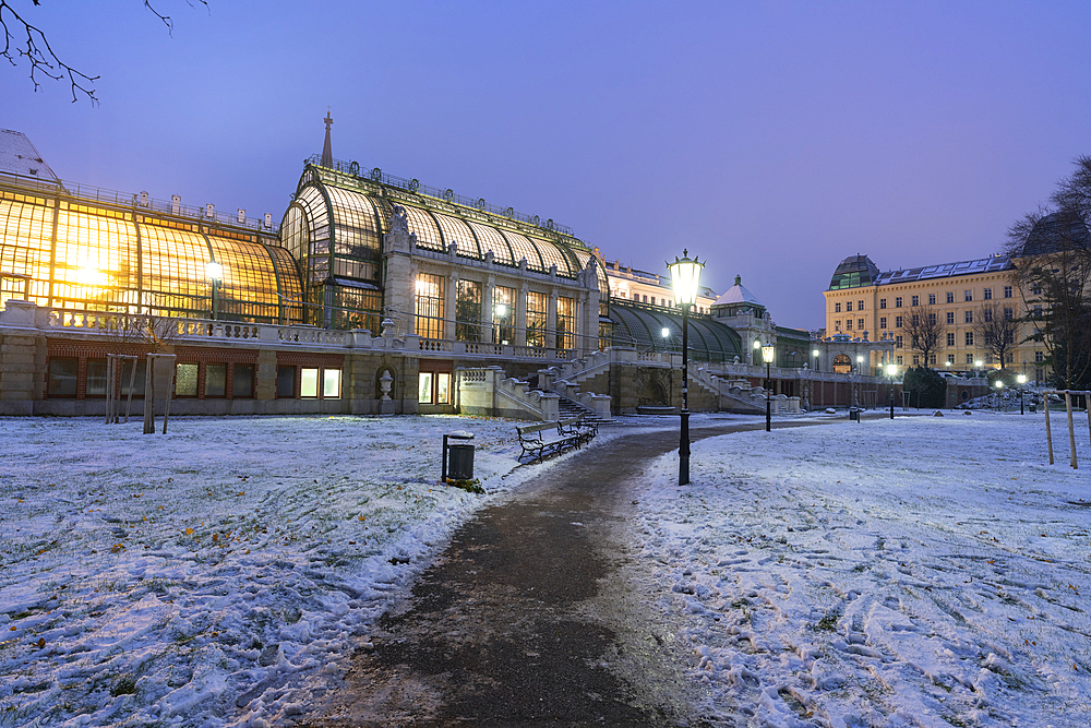 Palmenhaus greenhouse view from the Hofburg palace gardens covered with snow, Burggarten, Vienna, Austria, Europe