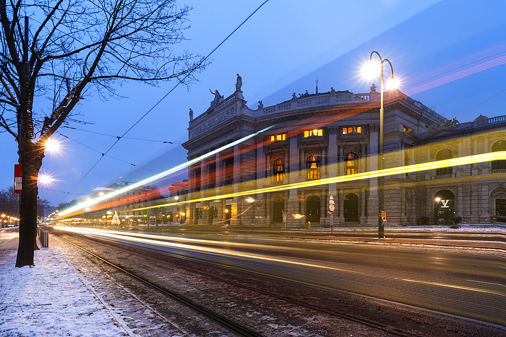 Lights of car trails on the icy road beside the famous Burgtheater (Austrian National Theatre), Vienna, Austria, Europe