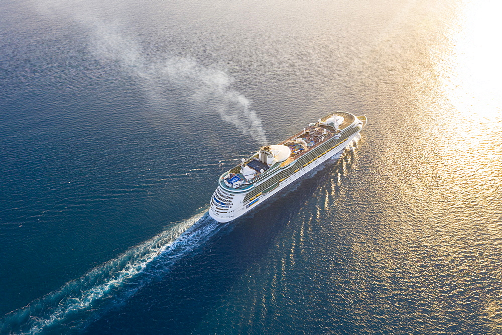 Cruise ship sailing in the Caribbean Sea at sunset, aerial view by drone, Antilles, West Indies, Caribbean, Central America