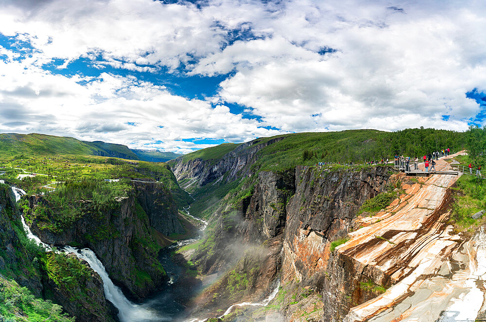 Hikers admiring Voringsfossen waterfall from the above canyon, Eidfjord, Hordaland county, Norway, Scandinavia, Europe