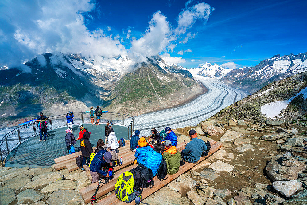 People admiring the majestic Aletsch Glacier from terrace at Eggishorn viewpoint, Bernese Alps, canton of Valais, Switzerland, Europe