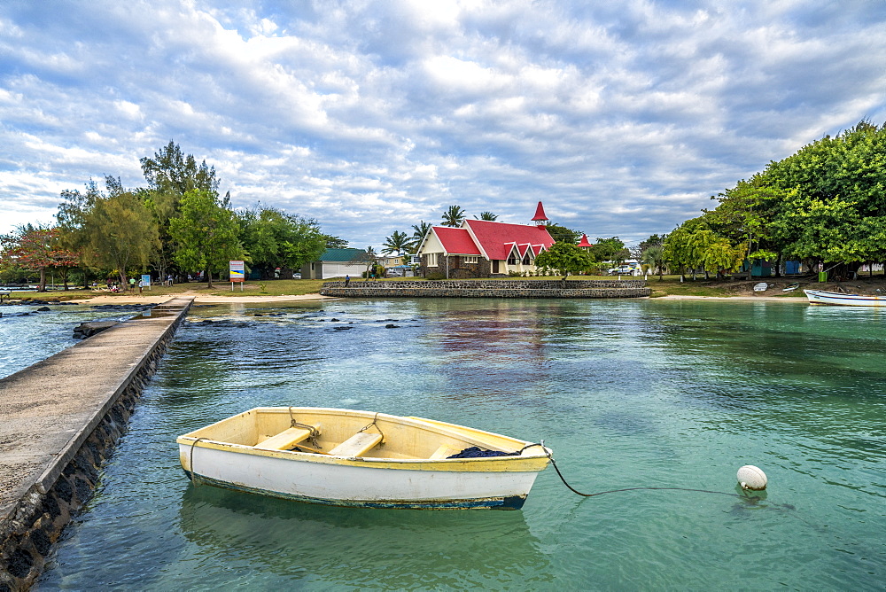 Boat moored in the sea surrounding the Notre Dame Auxiliatrice Church, Cap Malheureux, Mauritius, Indian Ocean, Africa