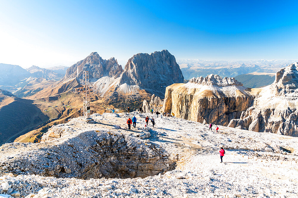 Hikers admiring Sella Pass, Sassolungo and Sassopiatto from top of Sass Pordoi, Dolomites, Trentino, Italy, Europe